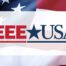 US Flag with IEEE-USA logo in front of it.